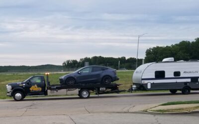 Tesla towing a camper to the recharging station.